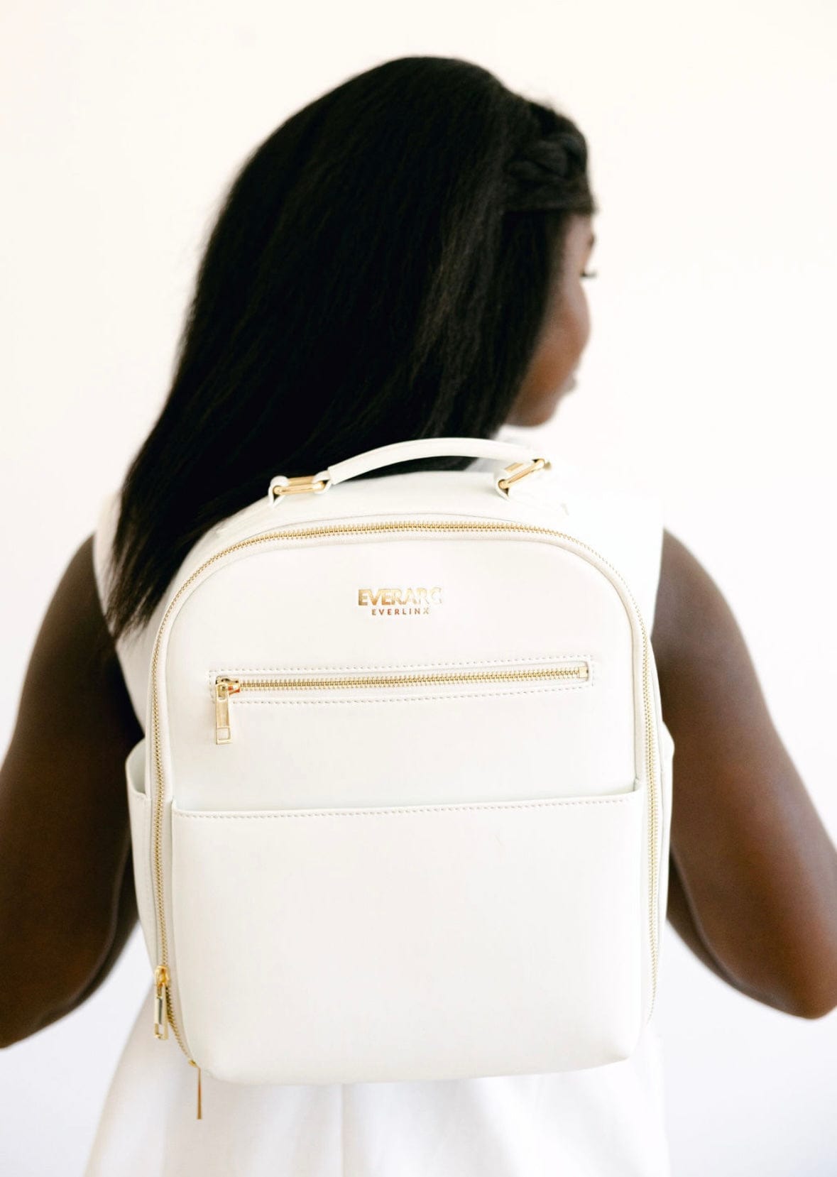 White backpack 154511C6 worn by woman