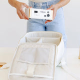 Woman holding Everarc device and backpack