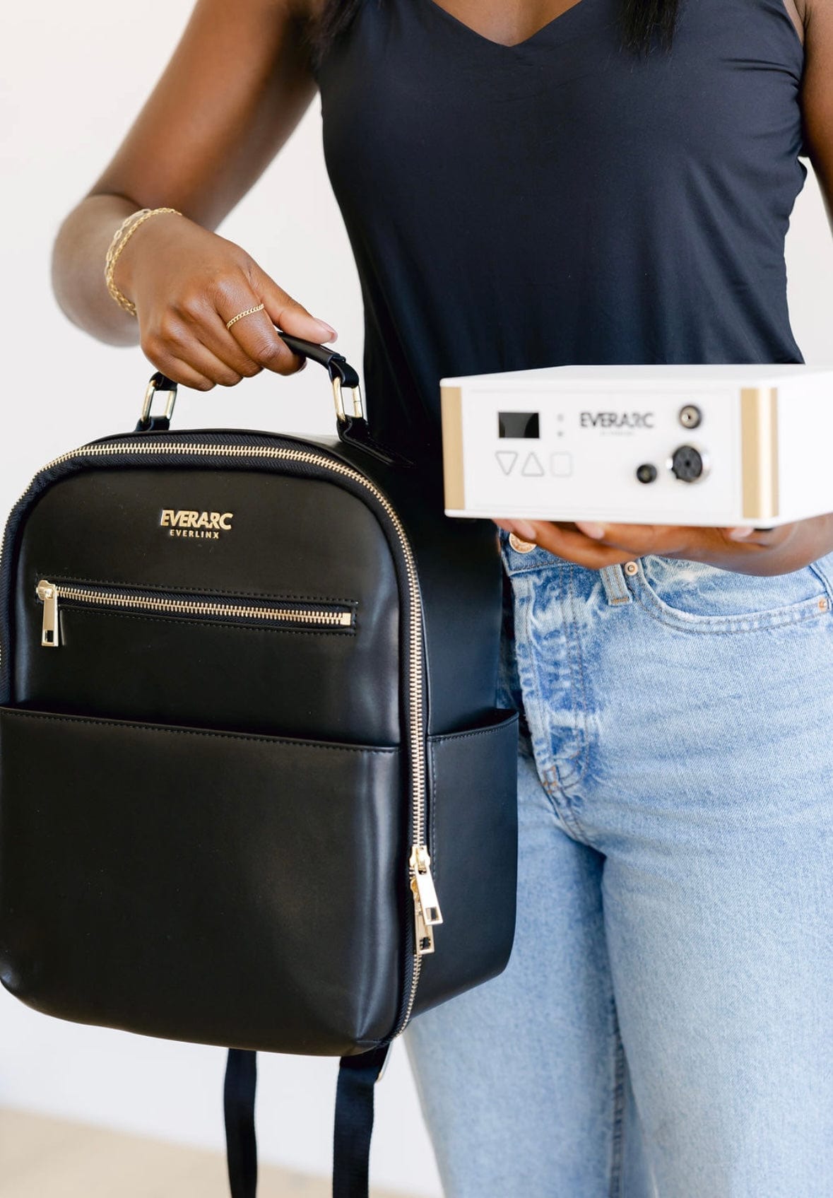 Woman holding Everarc backpack and device