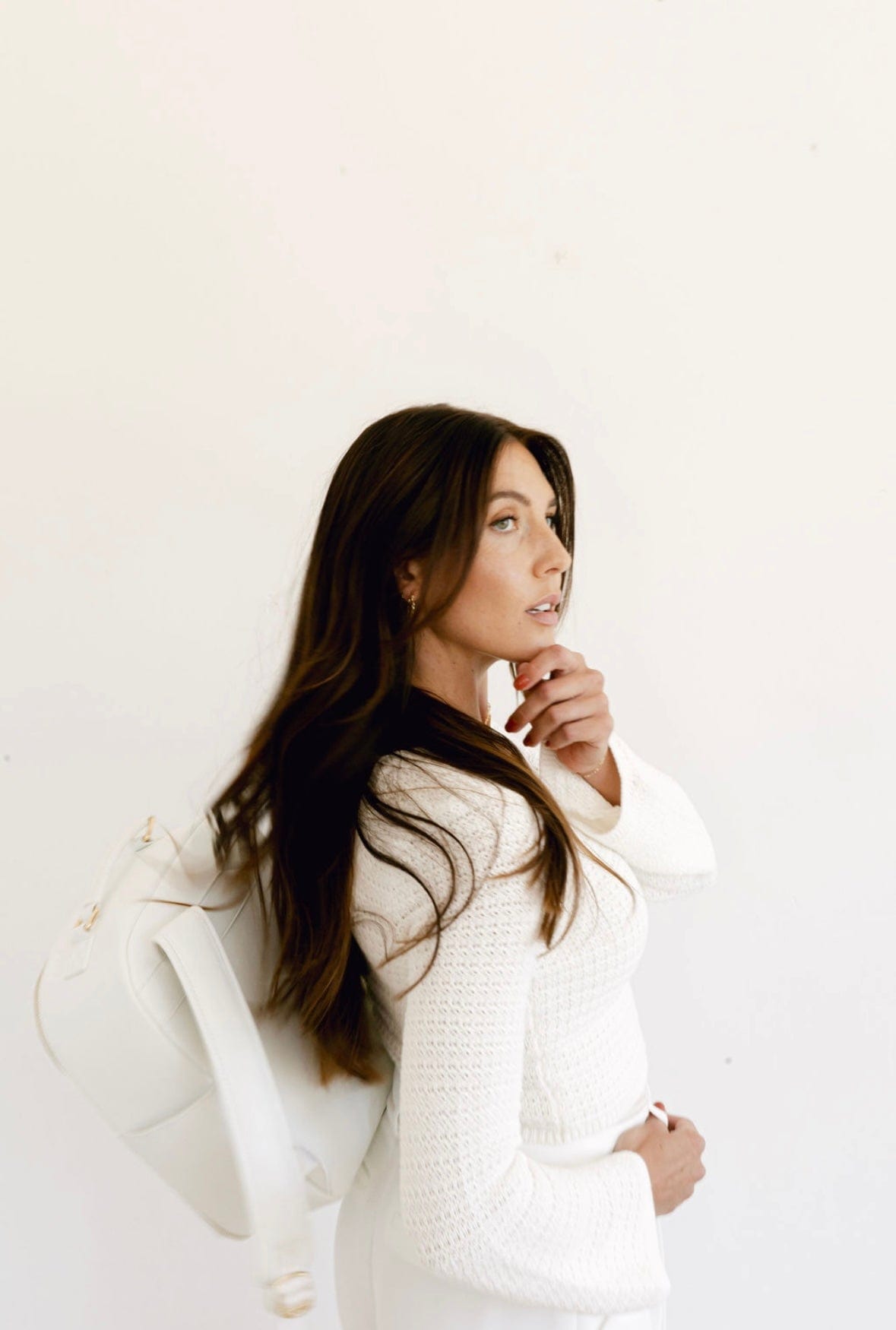 Woman in white outfit with backpack (92FB305A)
