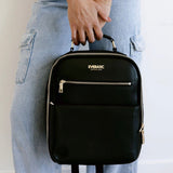 Woman holding black Everbasic backpack