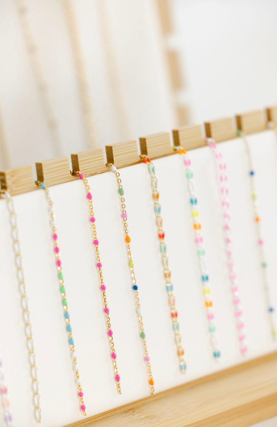 Necklaces with colorful beads on display.