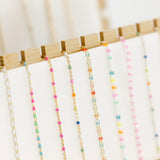 Necklaces with colorful beads on display.