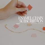 Hand holding color swatch with a necklace.