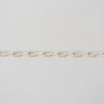 Gold chain on a light gray background
