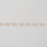 Gold chain on a light gray background
