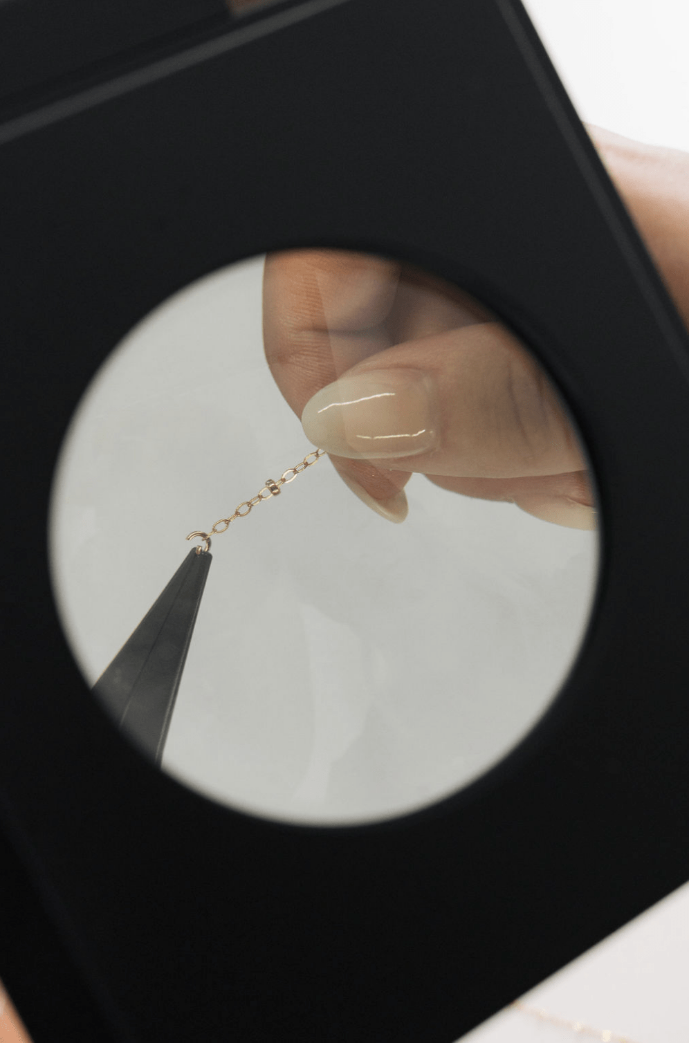 Jewelry chain repair under magnification, screenshot May 12, 2025.