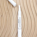 Everbright teeth whitening pen on wood grain