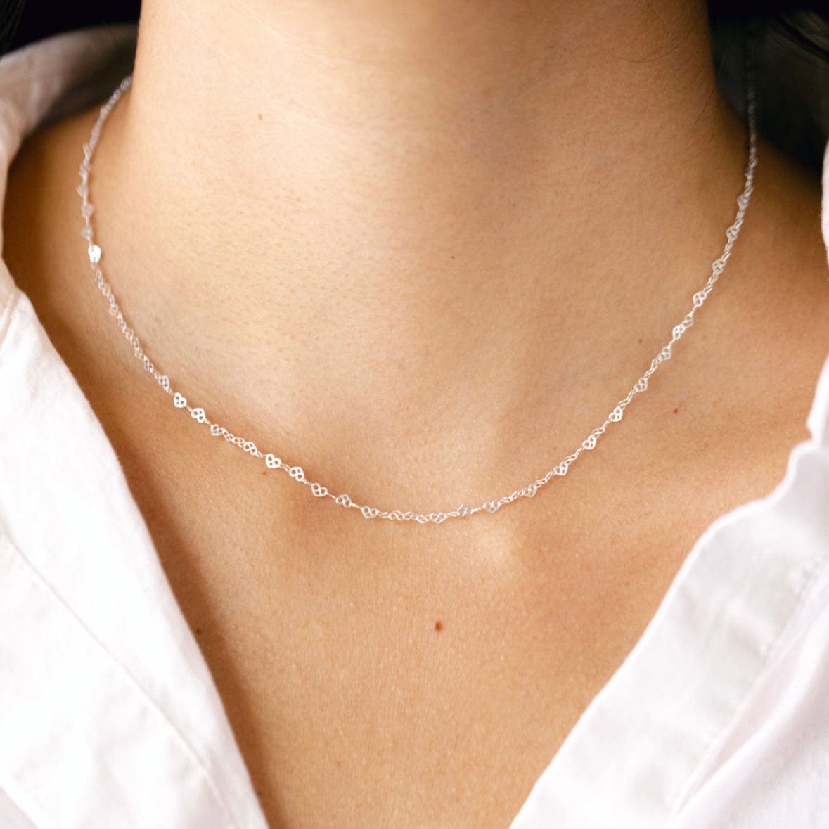 Silver necklace on a woman's neck - 05B49A9A-A02C
