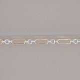 Gold and silver chain on a gray background