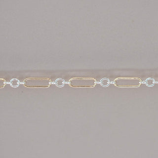 Gold and silver chain on a gray background