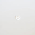 Small white heart with a face emoji on a light gray background