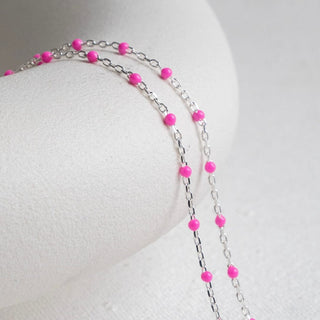 Pink beaded necklace on white background
