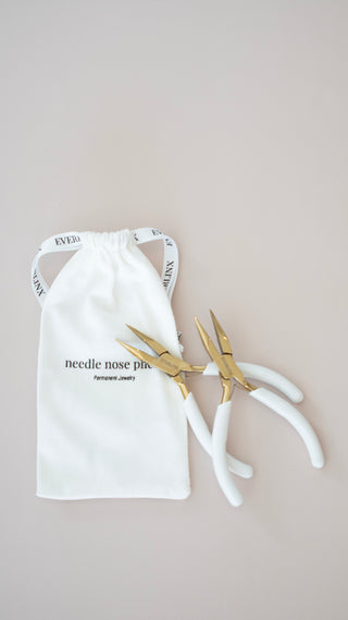 Pair of gold pliers on a white drawstring bag with text on a beige background