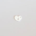 Heart-shaped number '4' charm on a light gray background