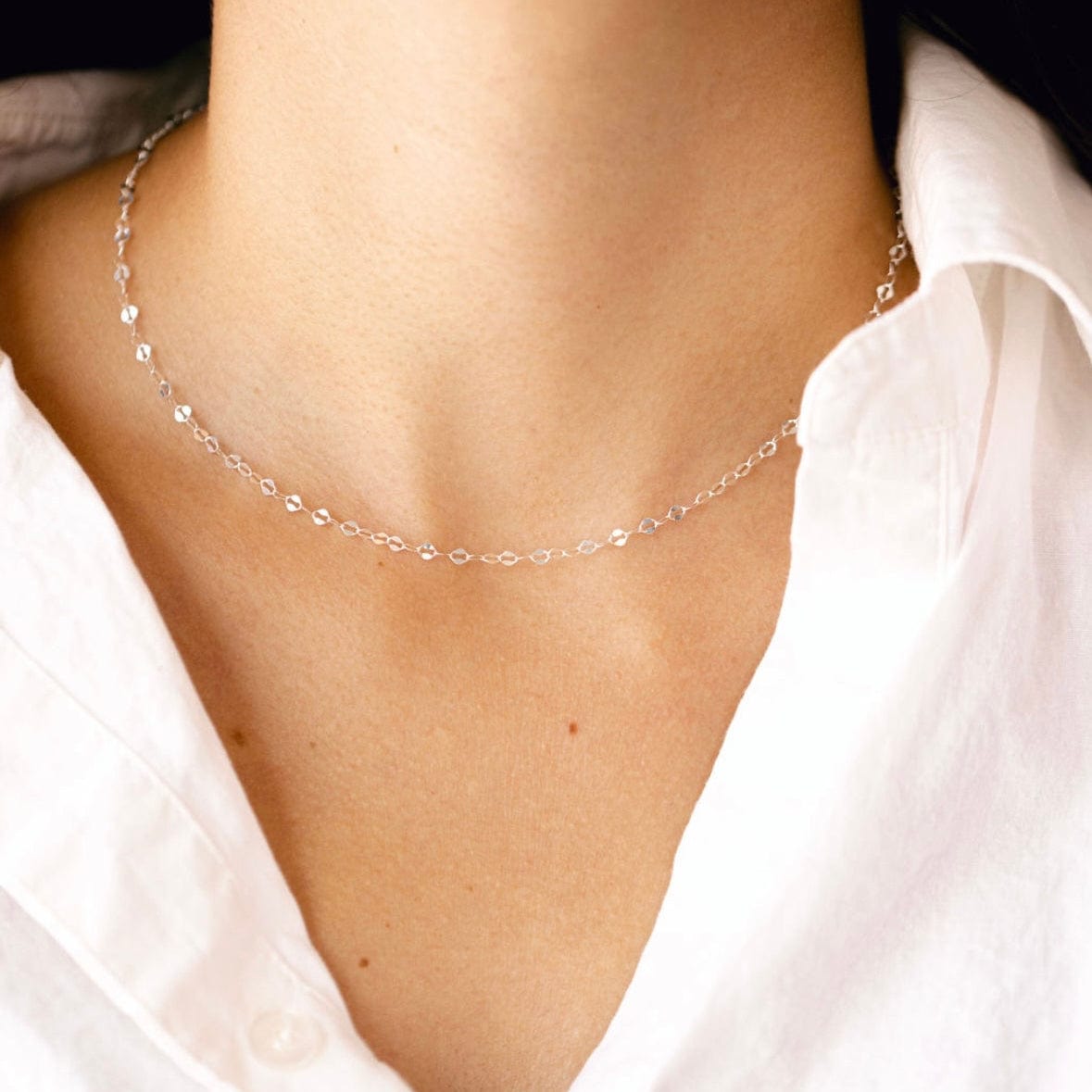Delicate silver necklace on white shirt, 284D0EFD-C22E-4FBE-9A6A-79558CEC9A6A