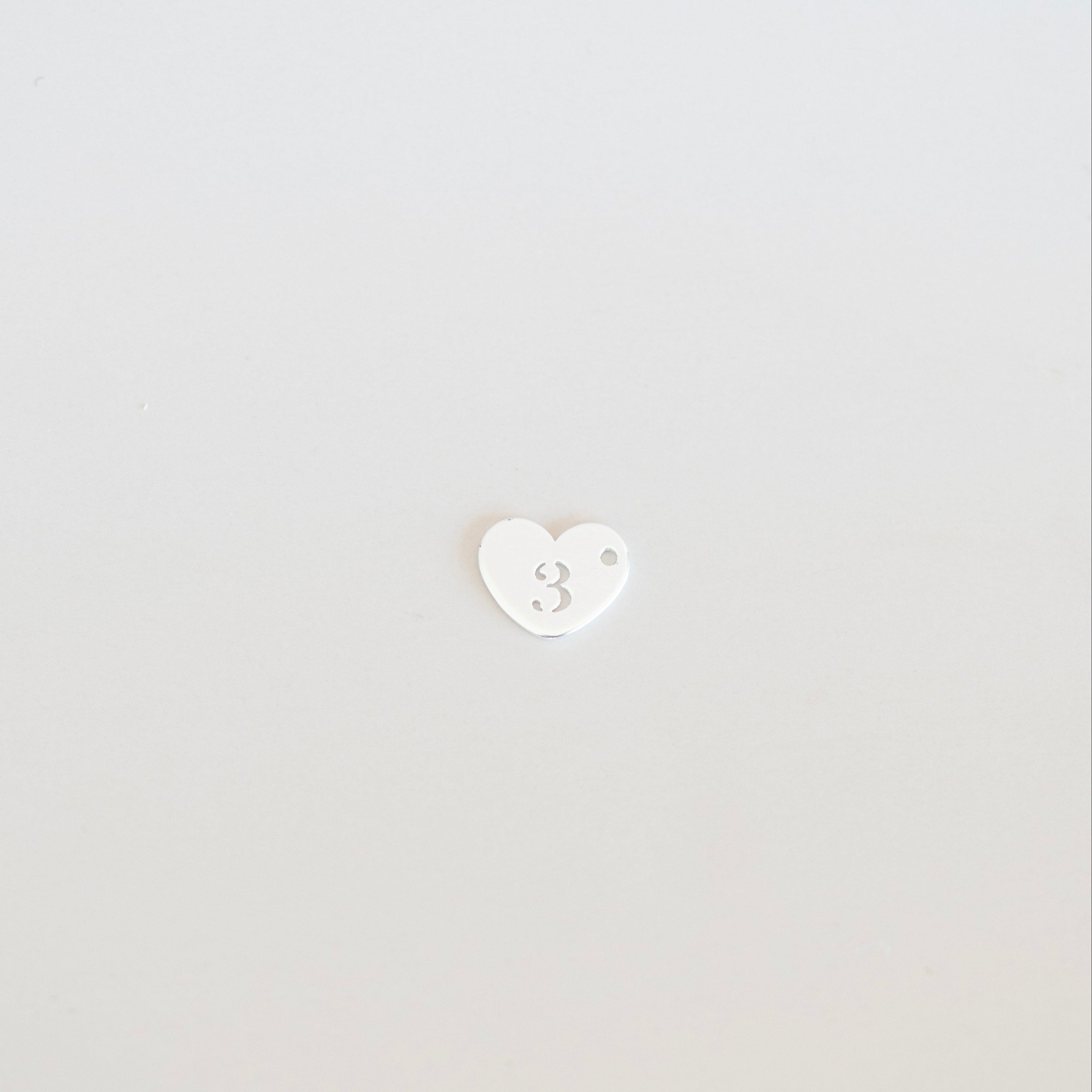 White heart-shaped object on a light gray background