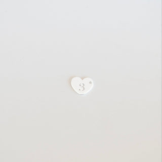 White heart-shaped object on a light gray background