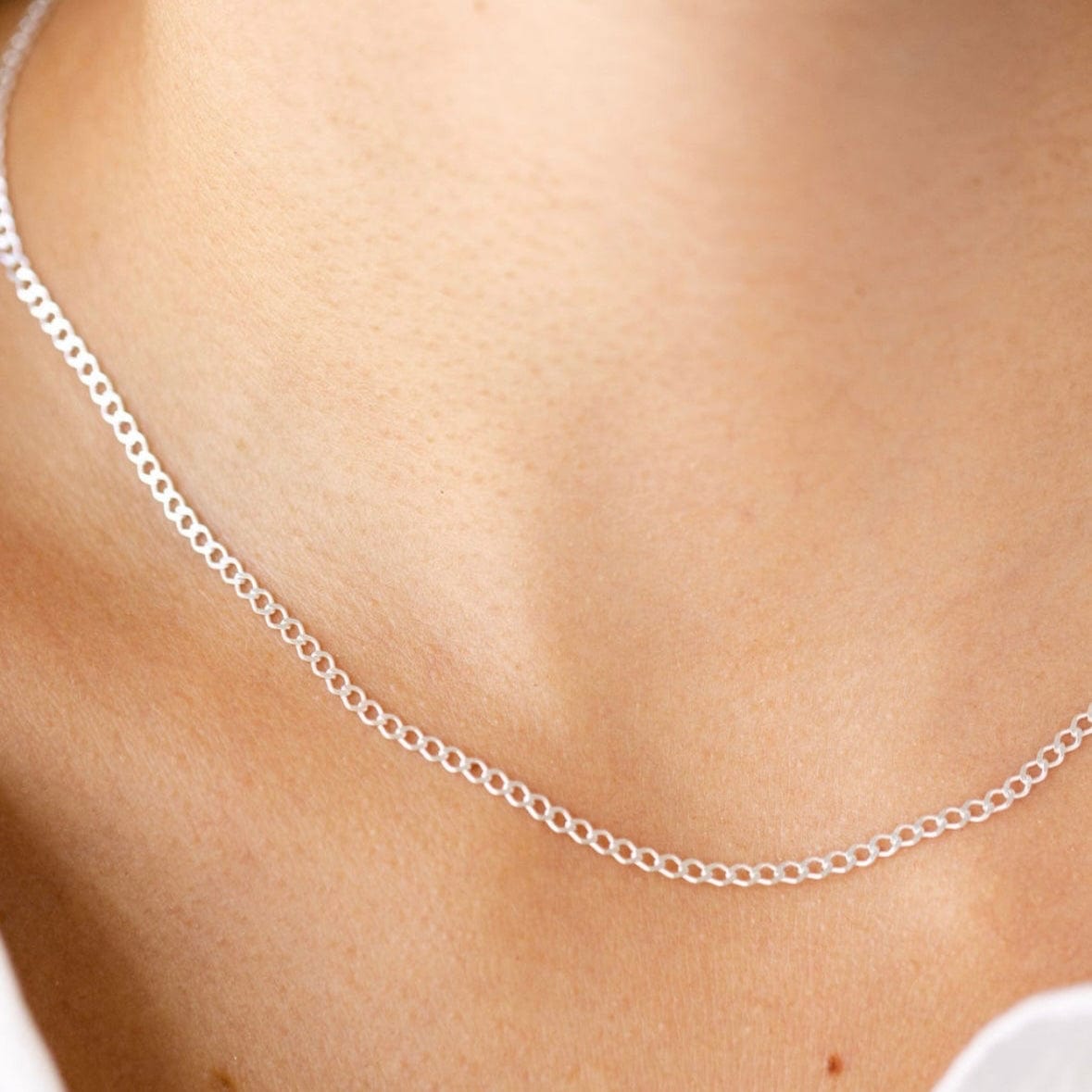Silver chain necklace on a woman's neck