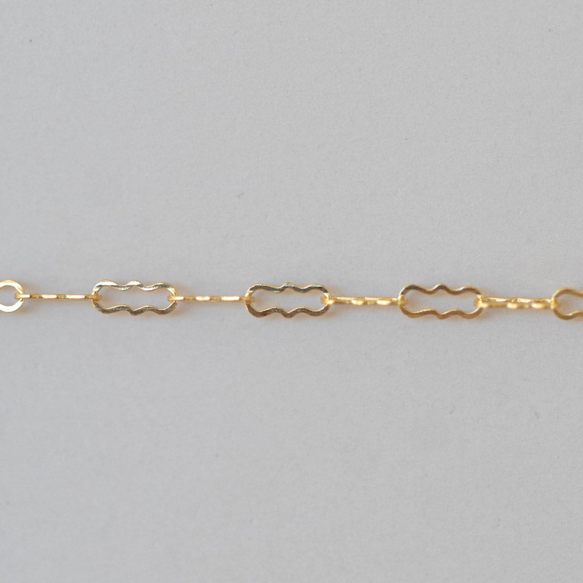 Gold chain on a gray background