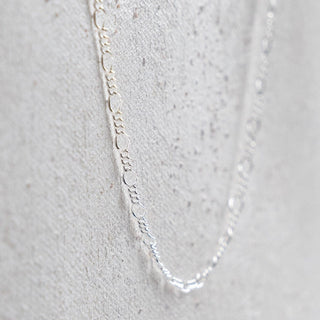 Silver chain necklace on white background