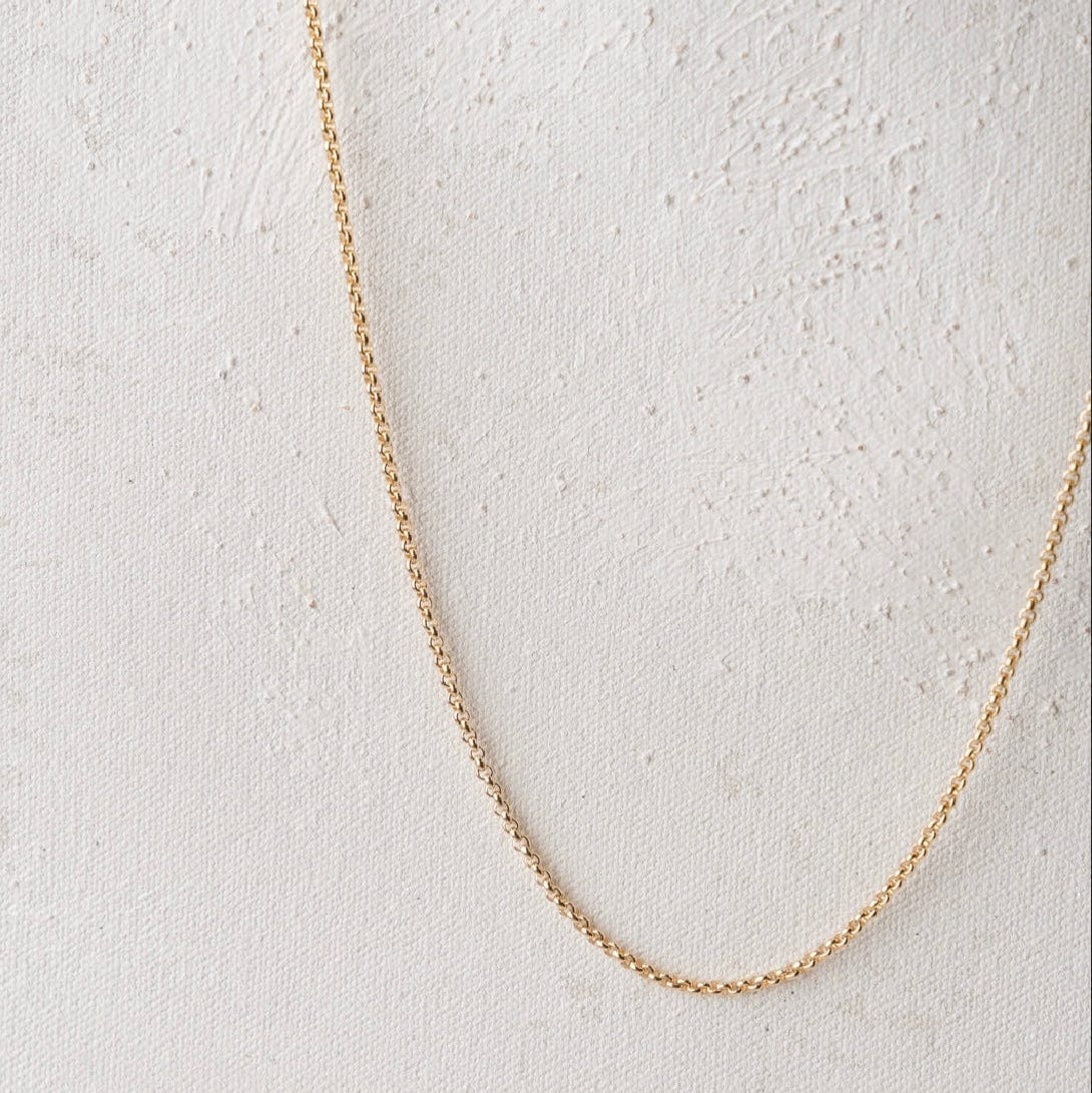 Gold chain necklace on white background