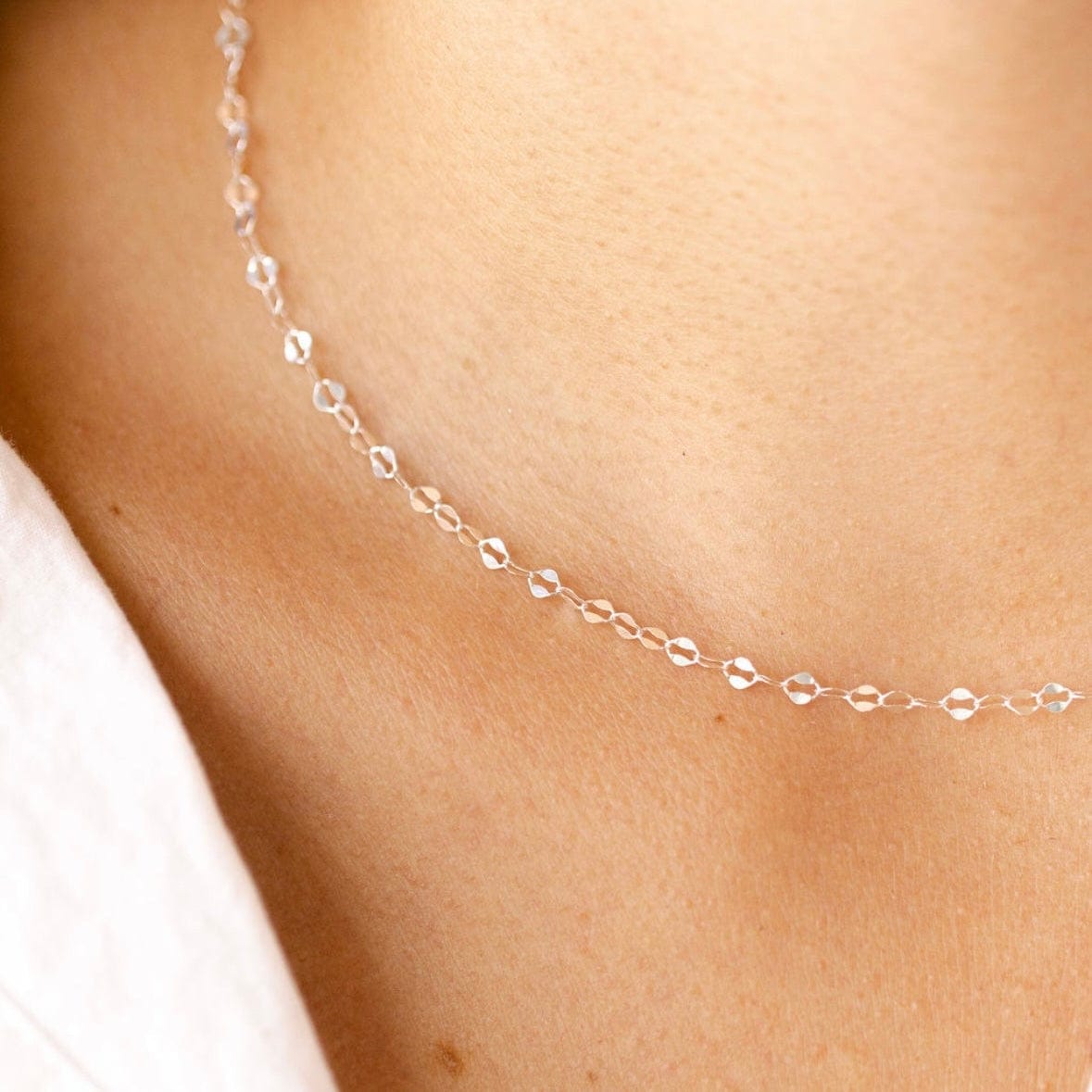 Silver chain necklace on neckline