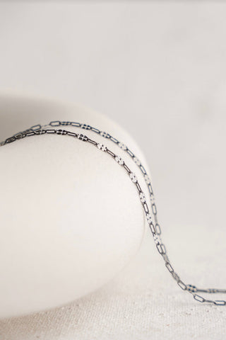 Silver necklace on white background - 6A6AE044
