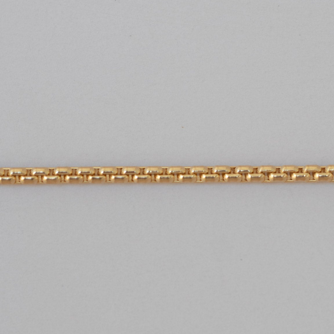 Gold chain on a gray background