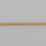 Gold chain on a gray background