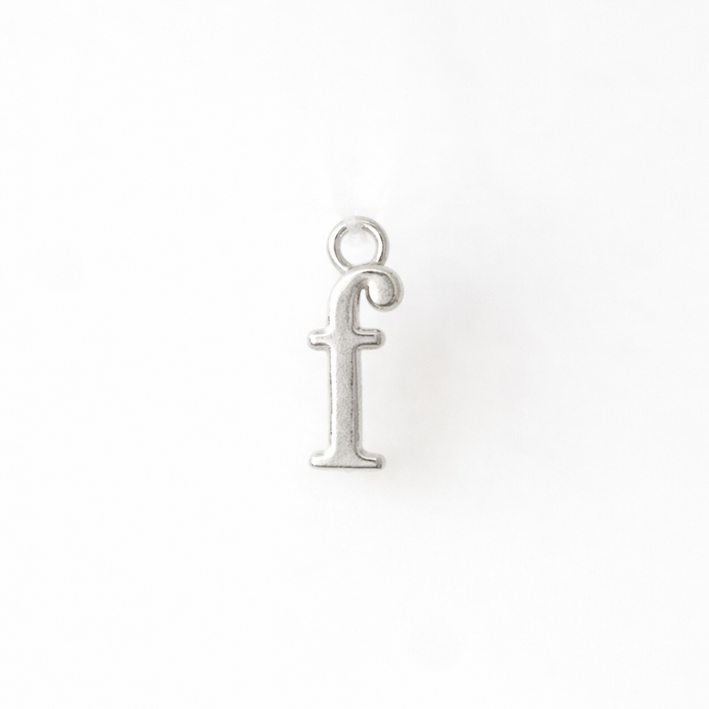 Silver 'f' pendant on a white background
