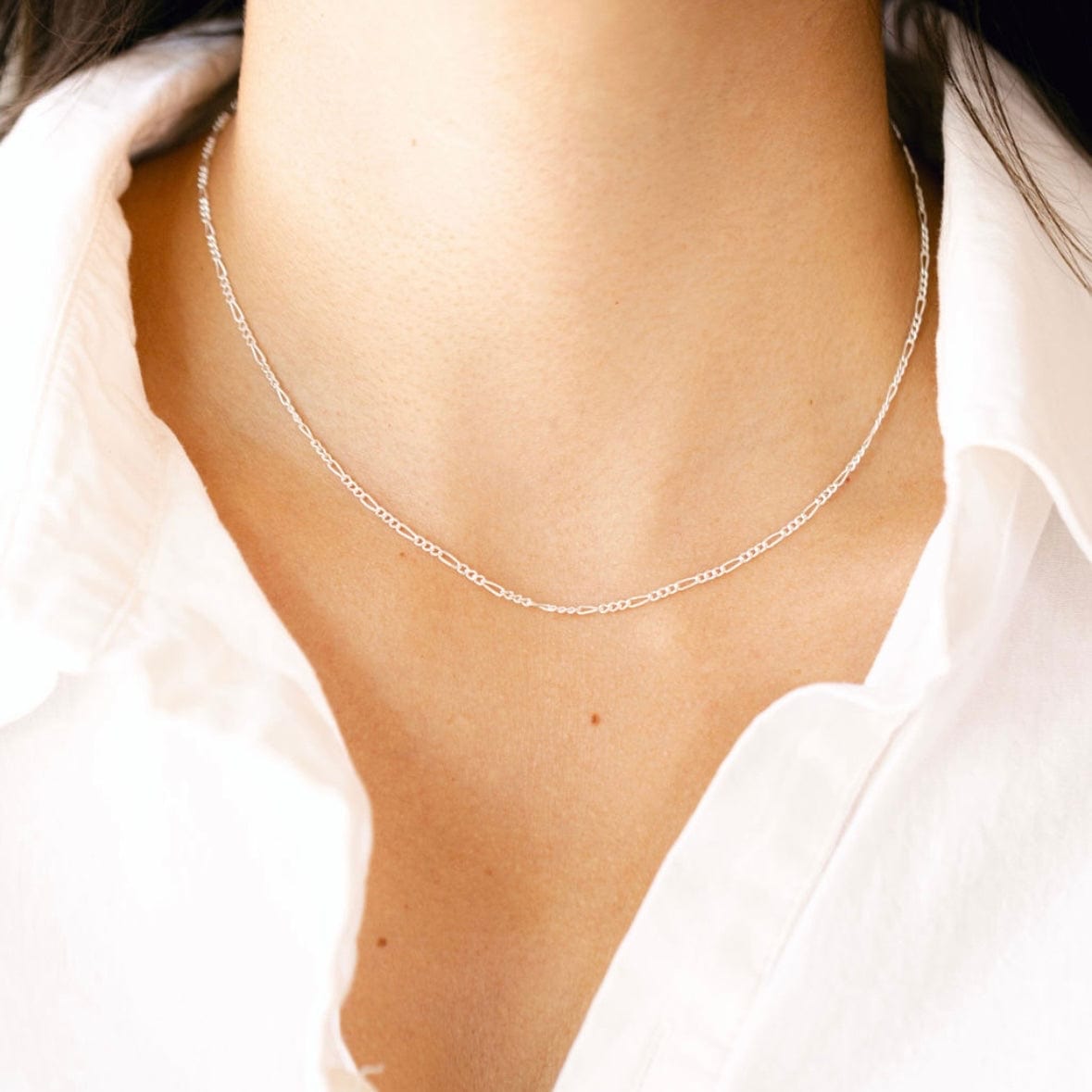 Silver necklace on white shirt