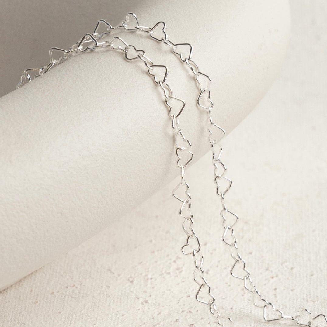 Silver heart chain necklace on white background