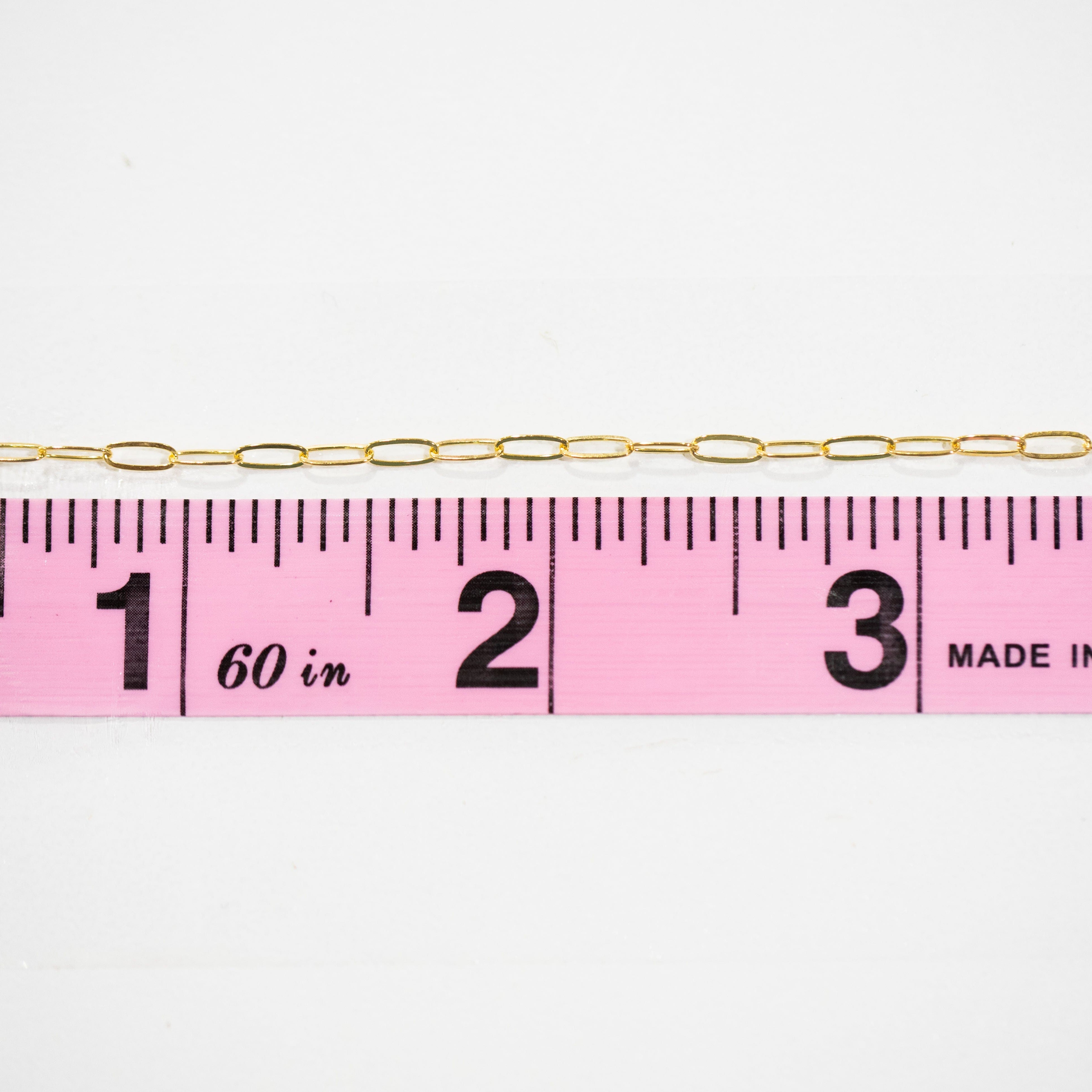 Chain10 gold chain next to ruler