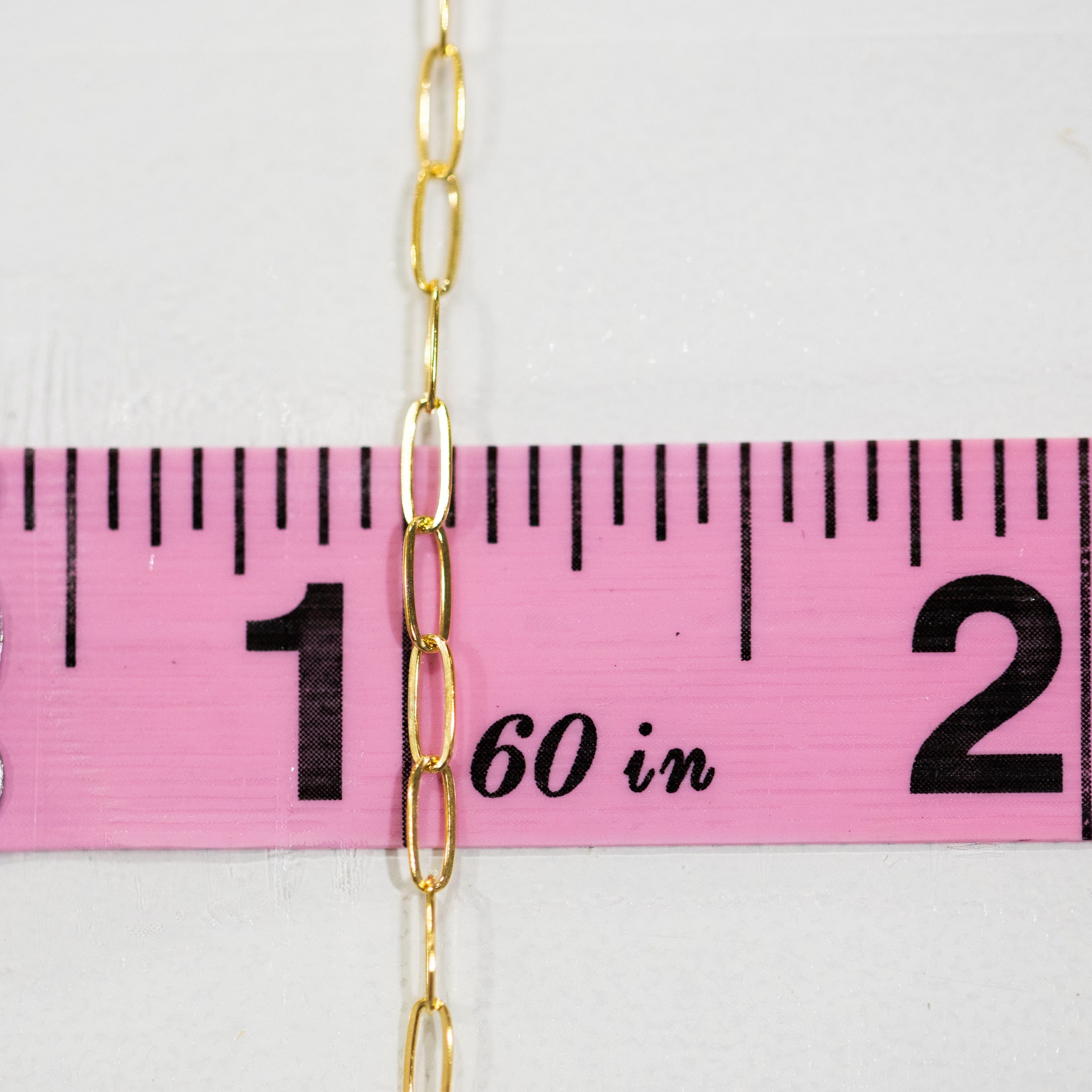 Chain10 gold chain measured against pink ruler