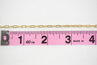Gold chain measured with pink ruler