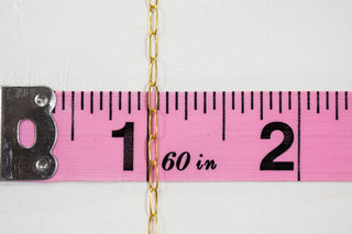 Gold chain measured on pink tape measure