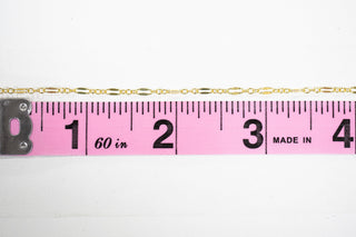 Chain28 gold chain with ruler measuring 4 inches.