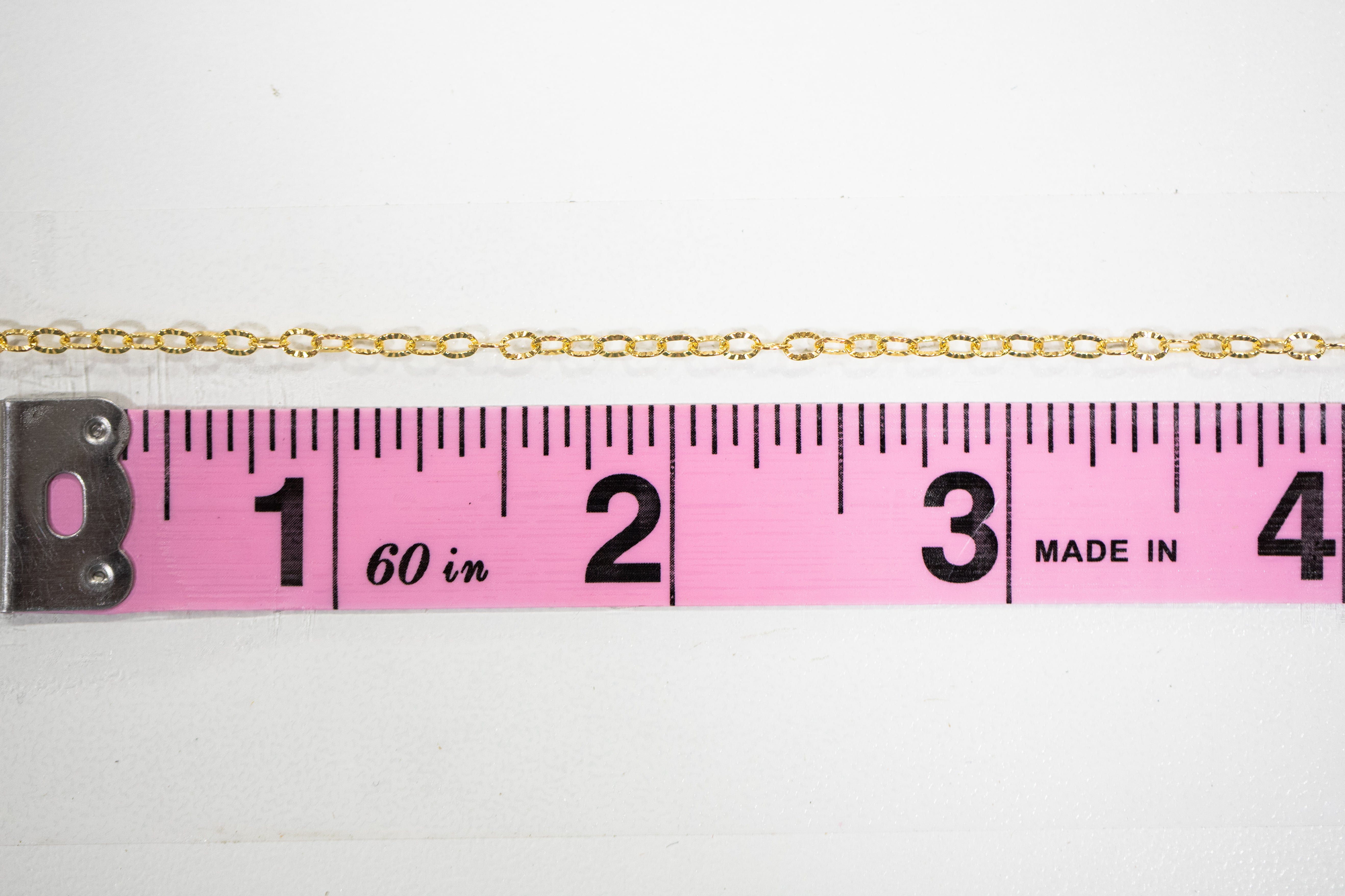Gold chain necklace Chain38 next to ruler