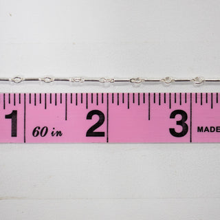 Silver chain with ruler showing measurement