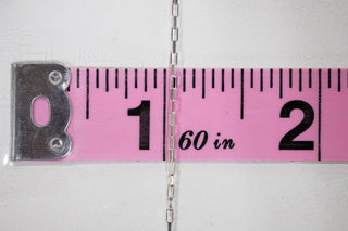 Silver chain (60 in) measured with pink ruler