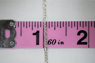 Silver chain 56-3 on ruler, showing length.