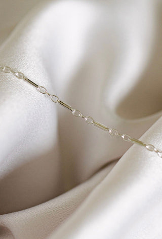 Silver chain necklace on silk