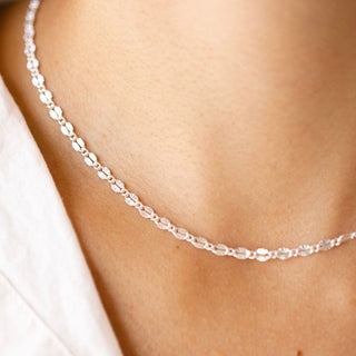 Silver chain necklace on a white shirt