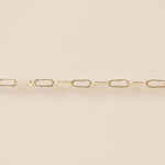 Gold chain on a beige background