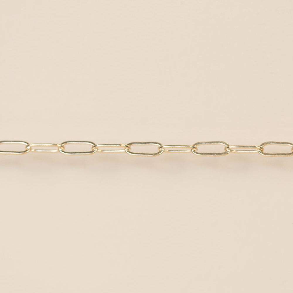 Gold chain on a beige background