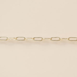 Gold chain on a beige background