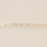 Gold chain on a beige background