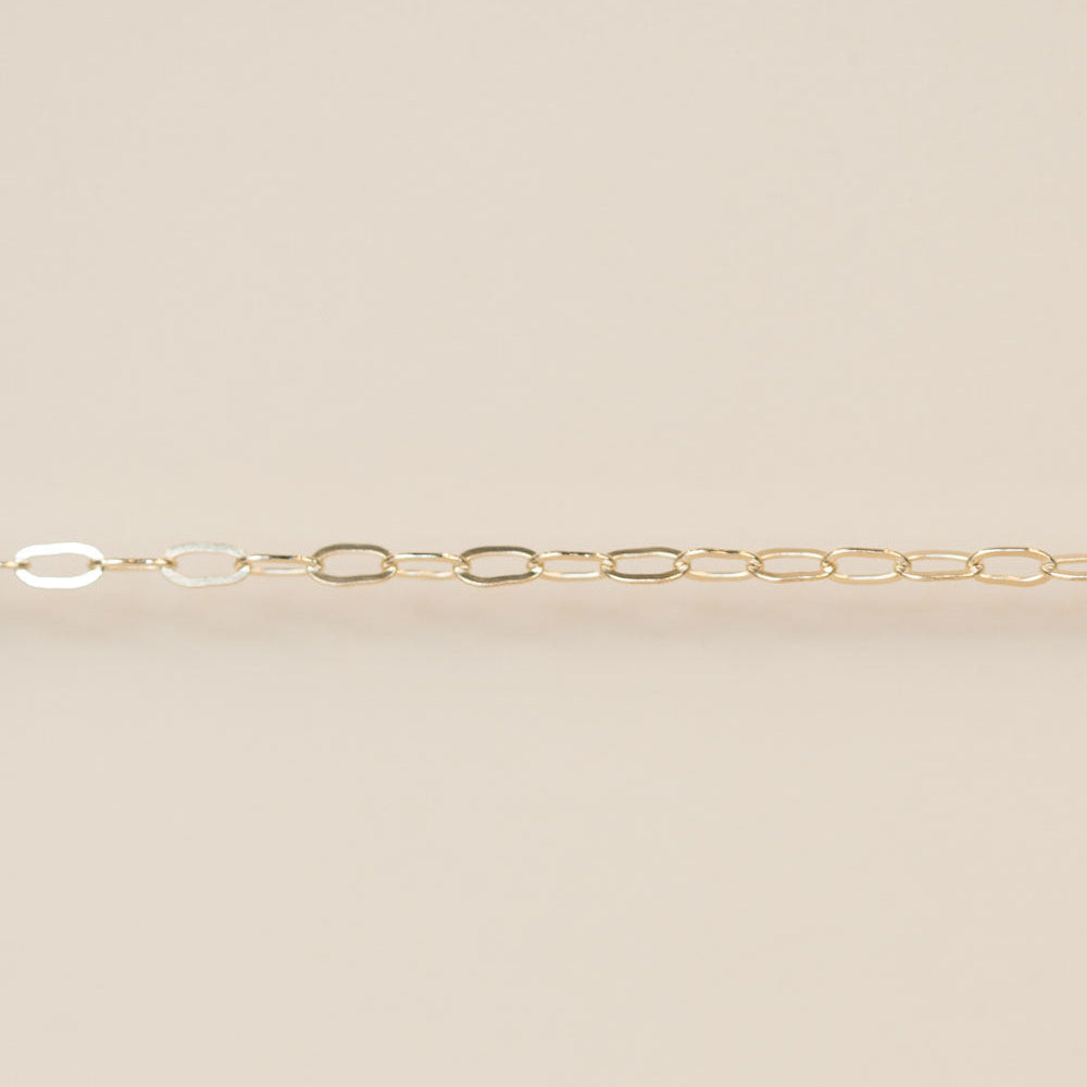 Gold chain on a beige background