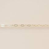Gold chain on a beige background